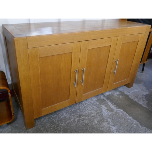 84 - An oak three door sideboard