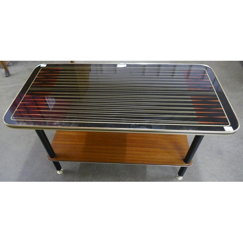 56 - A teak and black laminate Starburst pattern coffee table