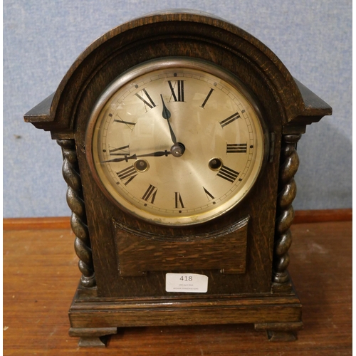 418 - An early 20th Century oak barleytwist mantel clock