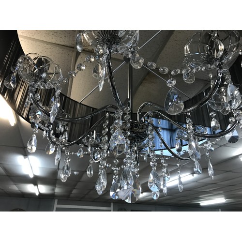 1438 - A chrome eight armed chandelier with black shade