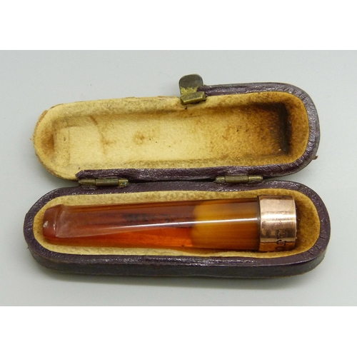 1010 - A cheroot holder with a 9ct gold mount, cased, case a/f