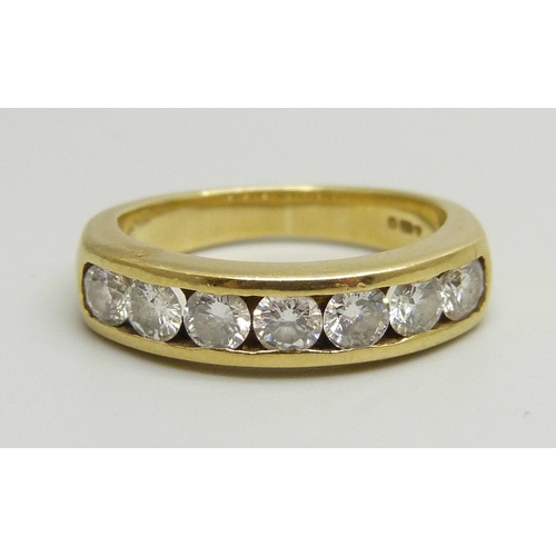 1020 - An 18ct yellow gold channel set half eternity ring with seven round brilliant cut diamonds, approxim... 