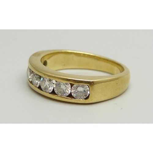 1020 - An 18ct yellow gold channel set half eternity ring with seven round brilliant cut diamonds, approxim... 