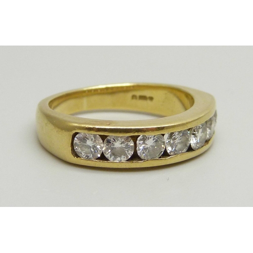 1020 - An 18ct yellow gold channel set half eternity ring with seven round brilliant cut diamonds, approxim... 