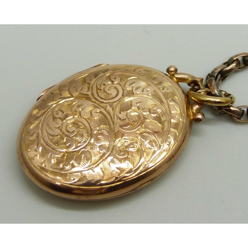 1025 - A 9ct gold engraved design locket, 4.4g, on an unmarked yellow metal faceted oval belcher chain neck... 