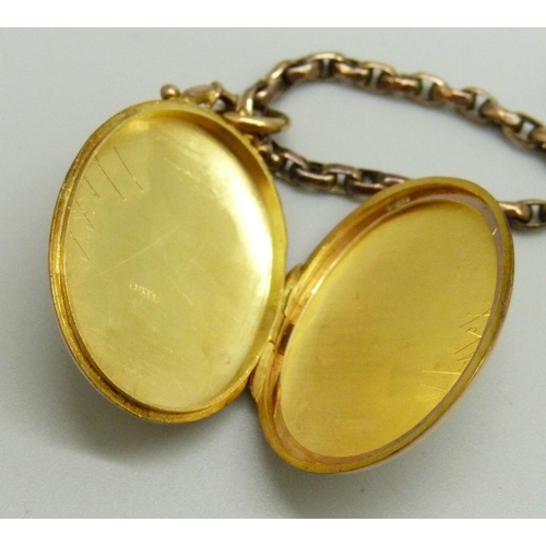 1025 - A 9ct gold engraved design locket, 4.4g, on an unmarked yellow metal faceted oval belcher chain neck... 