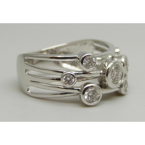 1027 - A 9ct white gold abstract design ring set with eight round brilliant cut diamonds, approximately 0.4... 