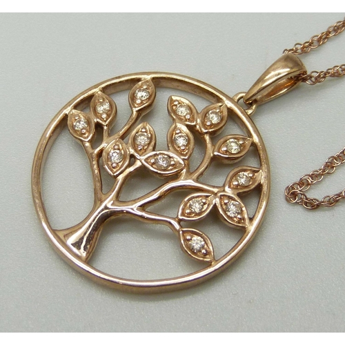 1034 - A 9ct rose gold pendant with tree of life design set with fourteen small diamonds, on a 9ct rose gol... 