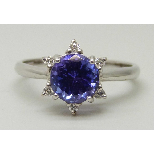 1035 - An 18ct white gold ring set with a round AAA grade tanzanite and six small round facet cut diamonds,... 