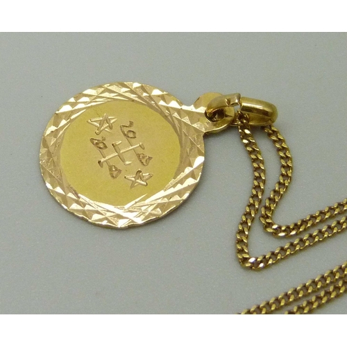 1036 - A yellow metal pendant with Arabic engraving (tests as 18ct gold), on an 18ct yellow gold fine curb ... 