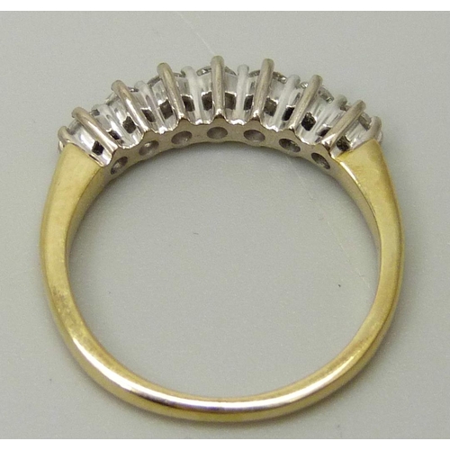 1038 - An 18ct yellow gold ring set with seven round brilliant cut diamonds, approximately 0.33ct, I/J colo... 