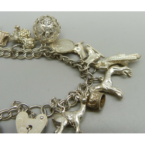 1050 - A silver charm bracelet, 40g