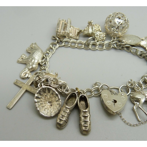 1050 - A silver charm bracelet, 40g