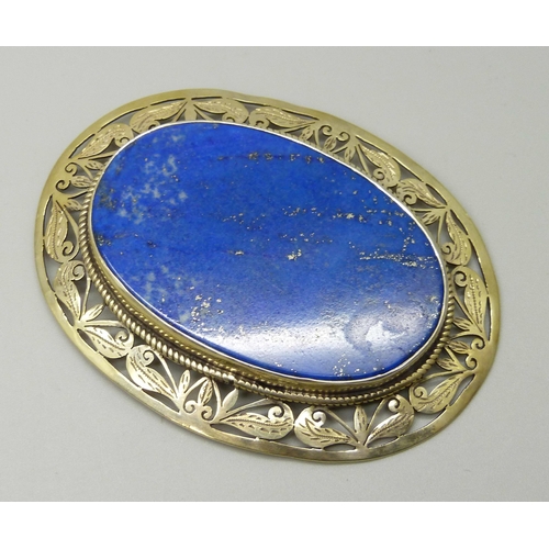 1055 - A large lapis lazuli and silver gilt brooch, 6cm x 8cm