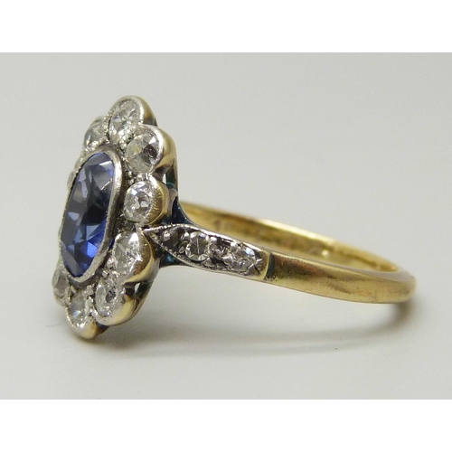 1076 - An 18ct gold, oval sapphire and diamond cluster ring, oval centre light blue sapphire measuring appr... 