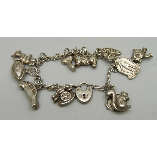 1103 - A small silver charm bracelet with nine charms, 42.6g