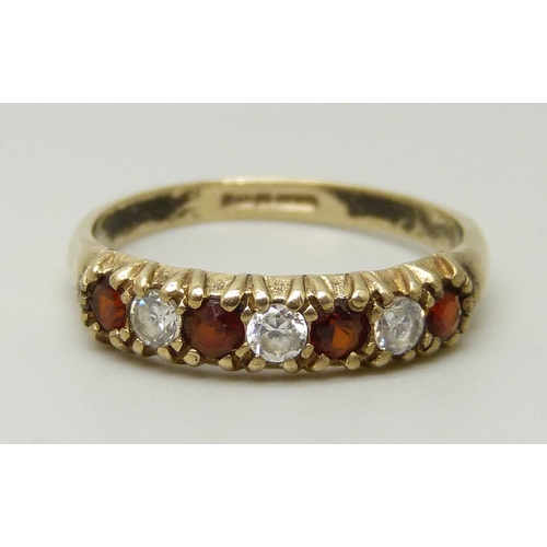 1105 - A 9ct gold, garnet and white stone ring, 1.4g, K