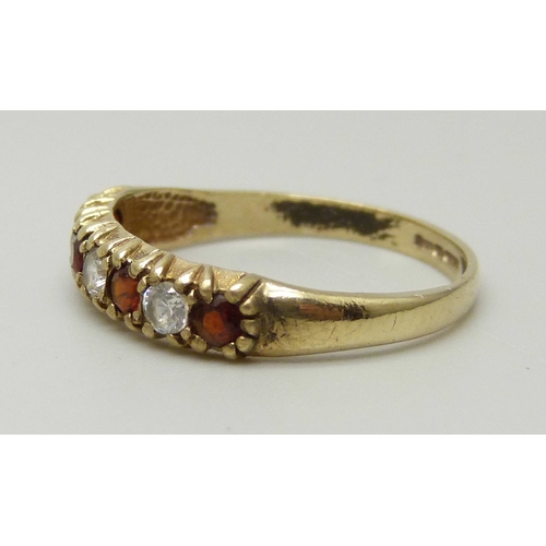 1105 - A 9ct gold, garnet and white stone ring, 1.4g, K