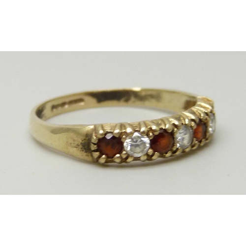 1105 - A 9ct gold, garnet and white stone ring, 1.4g, K