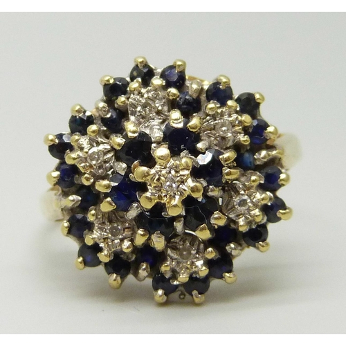 1110 - An 18ct gold, sapphire and diamond cluster ring, 6g, S/T