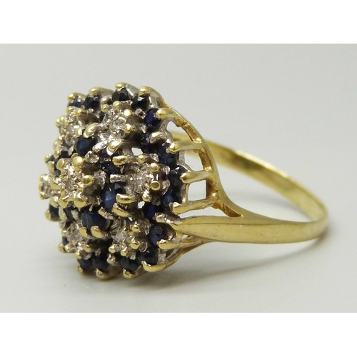 1110 - An 18ct gold, sapphire and diamond cluster ring, 6g, S/T