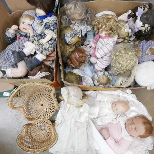 1235 - A collection of porcelain costume dolls, two wicker doll's chairs and a realistic baby doll with bed... 