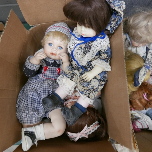 1235 - A collection of porcelain costume dolls, two wicker doll's chairs and a realistic baby doll with bed... 