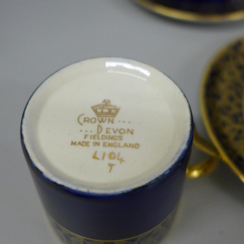 639 - A set of six Crown Devon Art Deco royal blue and gold coffee cans and saucers, crazing to base of ea... 