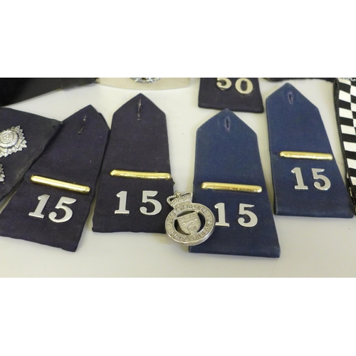 680 - A collection of Police memorabilia including leather belt, epaulettes, badges and buttons, the major... 