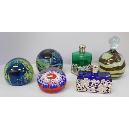 695 - Three Mdina glass paperweights, a Strathern pocket watch and two coloured glass scent bottles