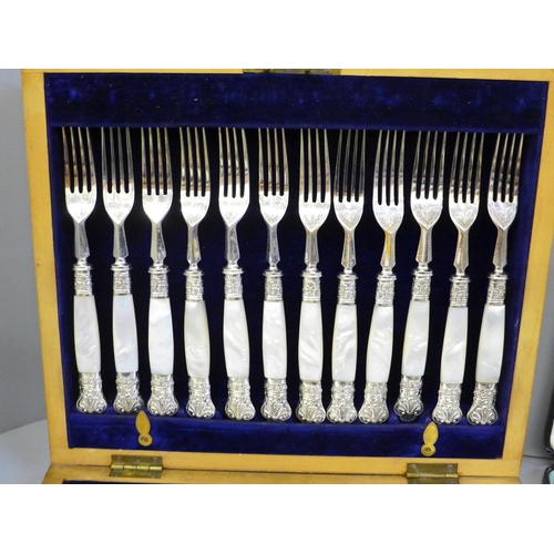 700 - A cased set of 24 silver plate and mother of pearl fish knives and forks, a cased set of six Walker ... 