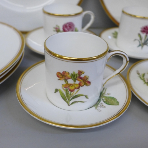 702 - A set of six Royal Worcester hand painted coffee cans, saucers and plates, decorated with flowers, o... 