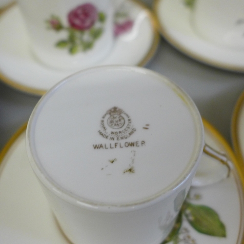 702 - A set of six Royal Worcester hand painted coffee cans, saucers and plates, decorated with flowers, o... 