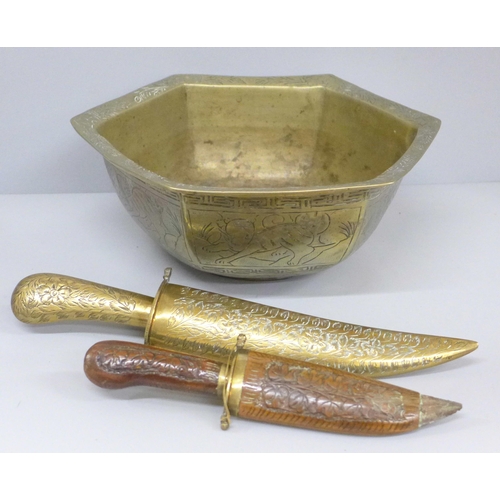 718 - Two brass daggers and a Chinese brass bowl