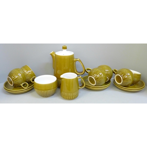 723A - A Langley Pottery coffee set; six cups, six saucers, a milk jug, sugar bowl and coffee pot