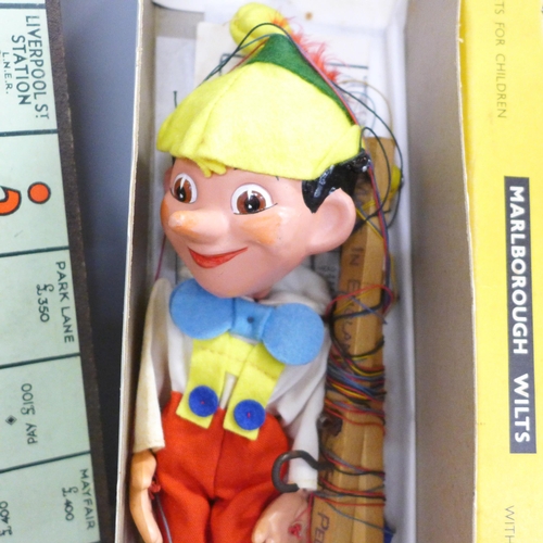 786 - A Pinocchio Pelham puppet and a vintage Monopoly game
