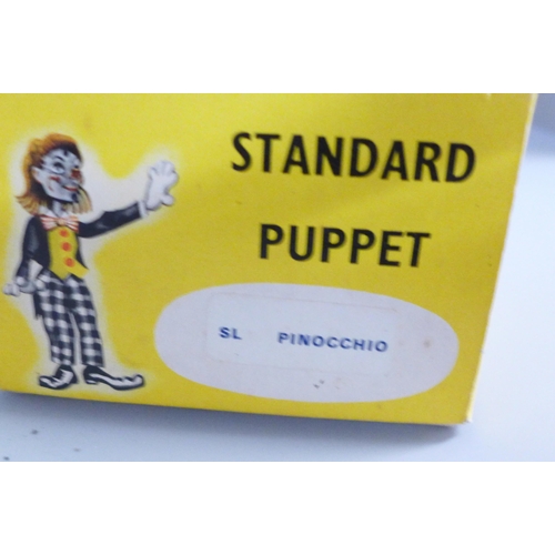 786 - A Pinocchio Pelham puppet and a vintage Monopoly game