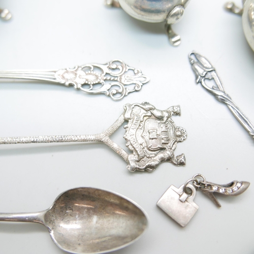 883 - A collection of silver including a pair of candlesticks, condiments, spoons, etc., 137g of weighable... 