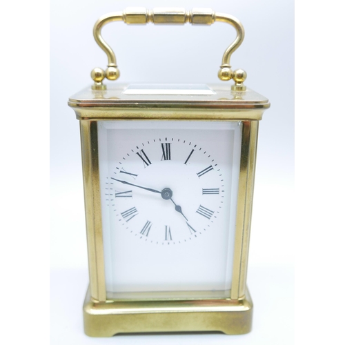 884 - A brass and glass sided carriage clock