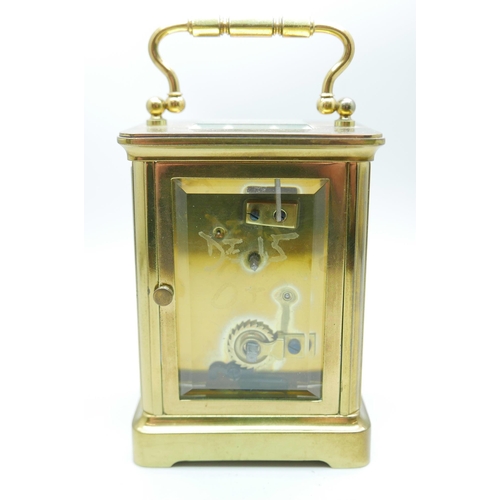 884 - A brass and glass sided carriage clock