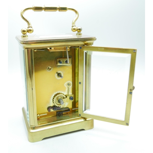 884 - A brass and glass sided carriage clock