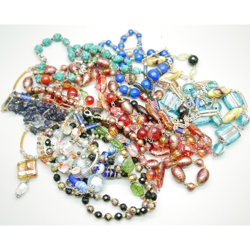 954 - A collection of glass necklaces, a Murano glass necklaces, an iolite bead necklace, etc.