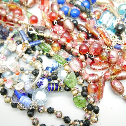 954 - A collection of glass necklaces, a Murano glass necklaces, an iolite bead necklace, etc.