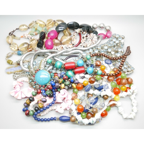 966 - A bag of assorted costume jewellery, blue rhinestone set belt, glass bangles, shell necklaces, etc.
... 