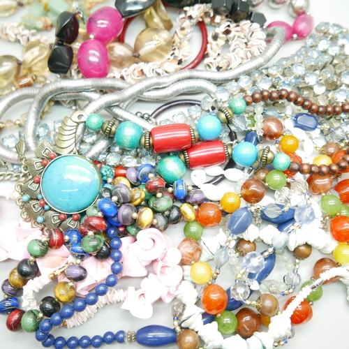 966 - A bag of assorted costume jewellery, blue rhinestone set belt, glass bangles, shell necklaces, etc.
... 