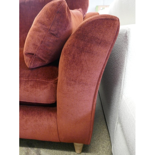 1505 - A rust velvet three seater sofa