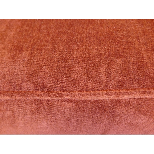 1505 - A rust velvet three seater sofa