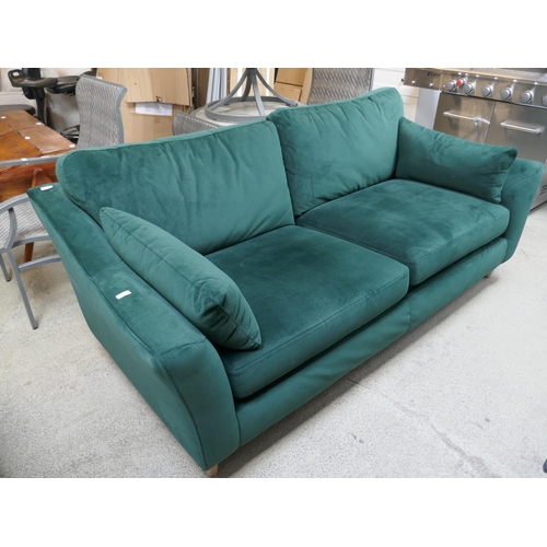 1525 - A green velvet three seater sofa, damaged frame