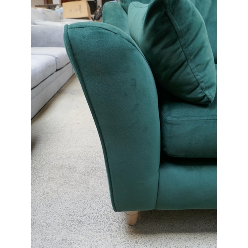 1525 - A green velvet three seater sofa, damaged frame