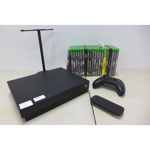 2089 - An Xbox One X console (model 1787) with media remote, matt black remote, headset stand and 21 games ... 